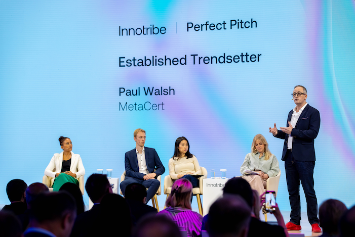 Paul Walsh from MetaCert speaking on stage at the Sibos Innotribe Perfect Pitch competition, category Established Trendsetter, with a panel of judges seated beside him and an audience watching.